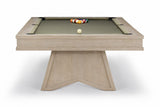 A modern pool table with a light oak wood frame and a green felt playing surface, featuring a geometric triangular base and racked billiard balls on a white background.