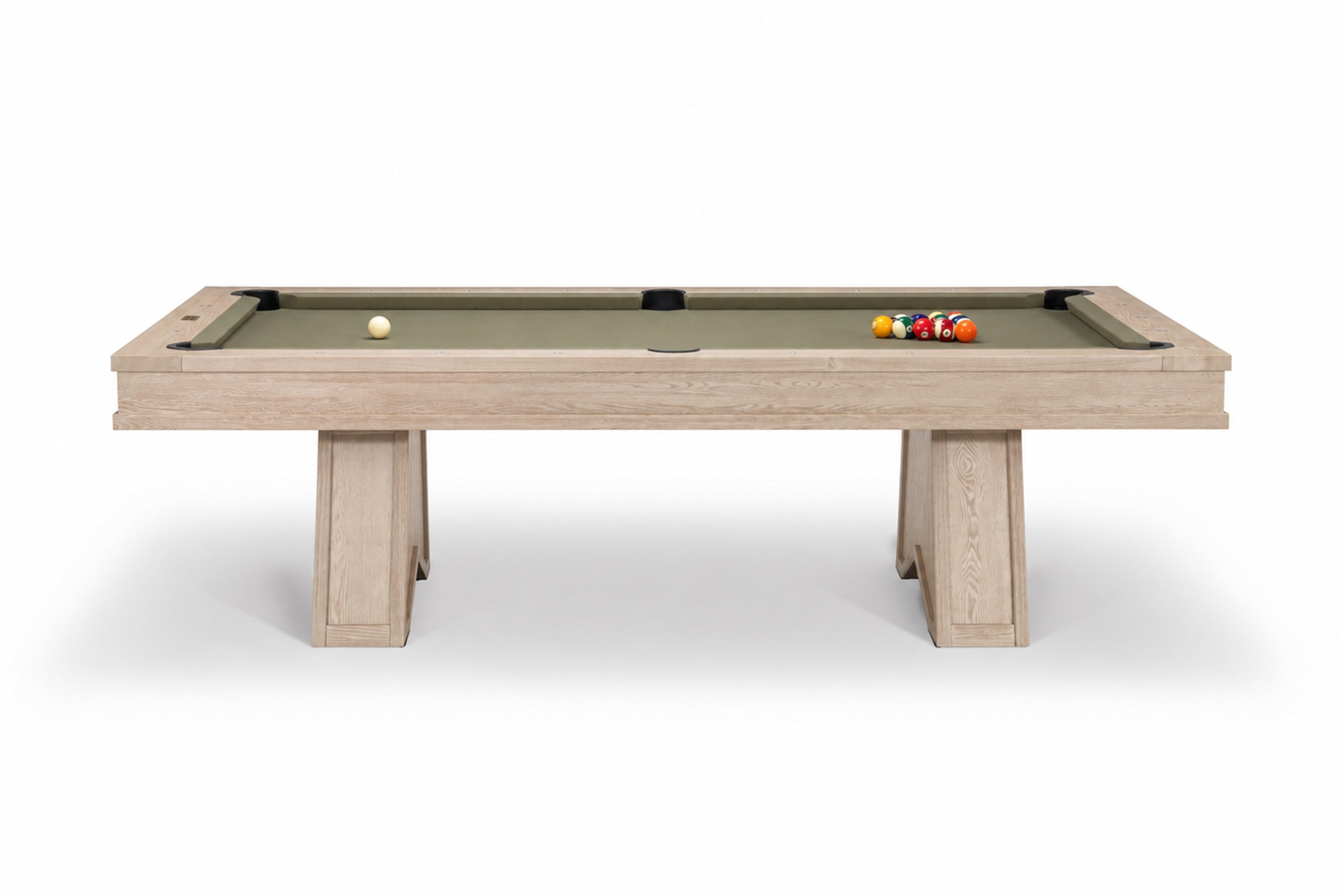 A modern pool table with a light beige wood-grain frame and a sage green felt surface, shown on a clean white background with a few billiard balls on the table.