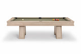 A modern pool table with a light beige wood-grain frame and a sage green felt surface, shown on a clean white background with a few billiard balls on the table.