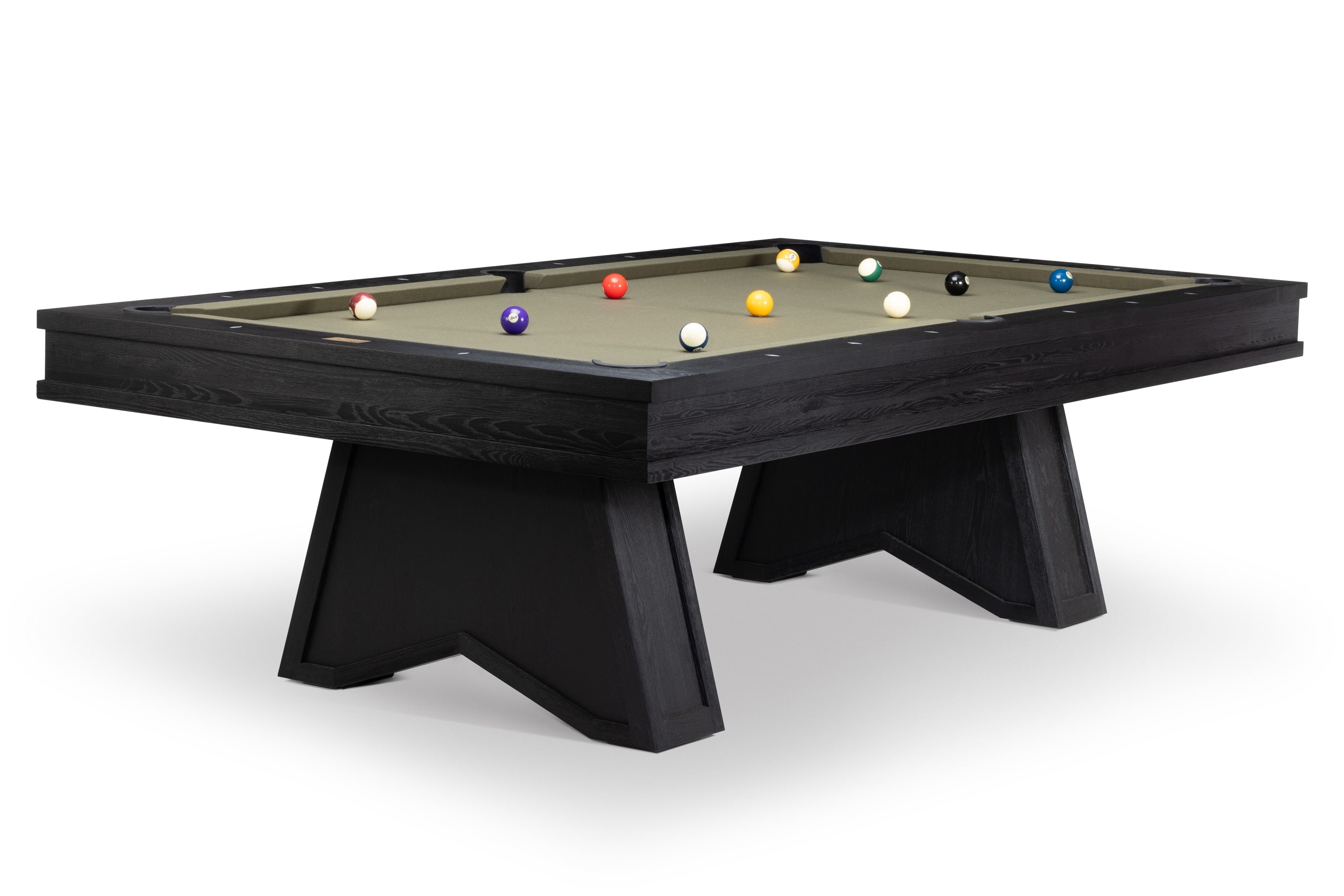 A modern pool table with a dark wood frame and angled legs, featuring a green felt surface with various colored billiard balls, shown on a white background.