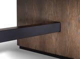 Close-up of a modern table featuring a matte black rectangular pedestal leg and a dark brown wood grain tabletop.