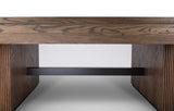 Close-up of a modern wooden table or console table showing the thick wood grain top, fluted side supports, and a black metal shelf rail underneath, photographed against a clean white studio background.