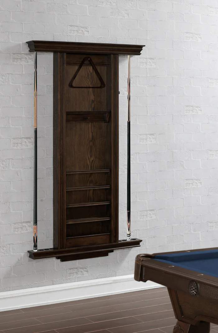 Wooden pool cue cabinet against a white brick wall with a pool table in the foreground.